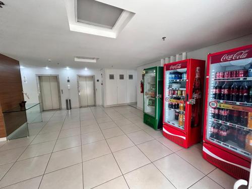 a store with two soda machines in a hallway at 902. Flat Blend - Proibido fumar in Brasilia