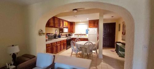 a kitchen and dining room with a table and chairs at Beachfront condo in Los Cabos, Mexico in San José del Cabo