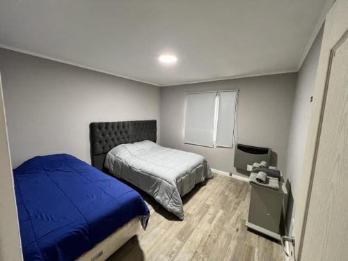 a bedroom with a bed and a tv in it at Casa Náutico con estacionamiento privado in Río Gallegos