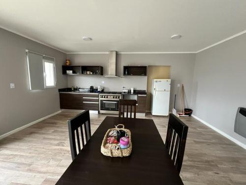 a kitchen with a table with a purse on it at Casa Náutico con estacionamiento privado in Río Gallegos