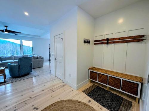 a living room with a couch and a fireplace at 2M New rustic contemporary home with stunning views, great amenities and perfect private location. in Franconia