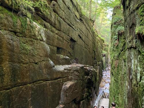 a group of people standing next to a rock wall at 2M New rustic contemporary home with stunning views, great amenities and perfect private location. in Franconia