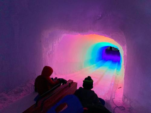 a group of people sitting in an ice cave at 2M New rustic contemporary home with stunning views, great amenities and perfect private location. in Franconia