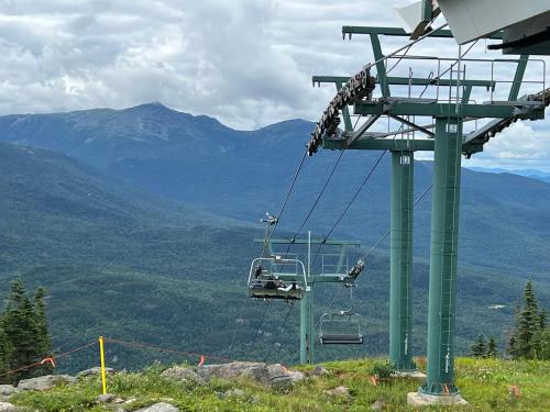 a gondola lift on top of a mountain at 2M New rustic contemporary home with stunning views, great amenities and perfect private location. in Franconia