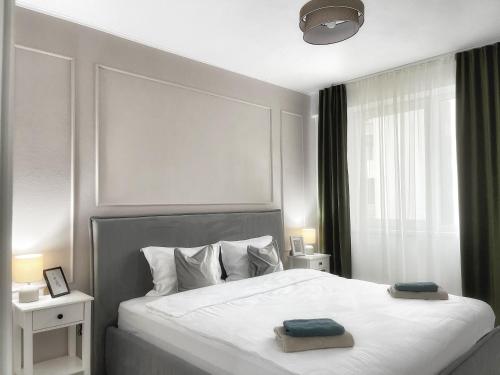 a bedroom with a bed with two towels on it at Noa Residence in Alba Iulia