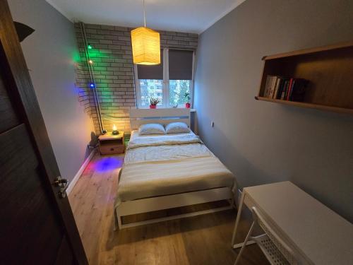 a small bedroom with two beds and a window at Poza zgiełkiem miasta, a jednak wszystko w zasięgu in Bydgoszcz
