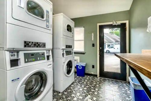 a laundry room with a washer and dryer at Pop-Of-Color - Loft - Downtown Raleigh - Near NCSU in Raleigh