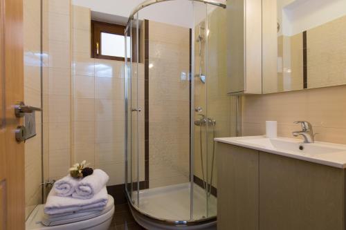 łazienka z prysznicem, toaletą i umywalką w obiekcie Kampos Villas, pure elegance, By ThinkVilla w mieście Achlades