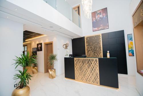 a lobby with a reception desk and plants at Twin Hotel Tanger in Tangier