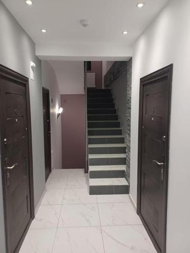 a hallway with a staircase in a building at Aparthotel Oltului in Galaţi