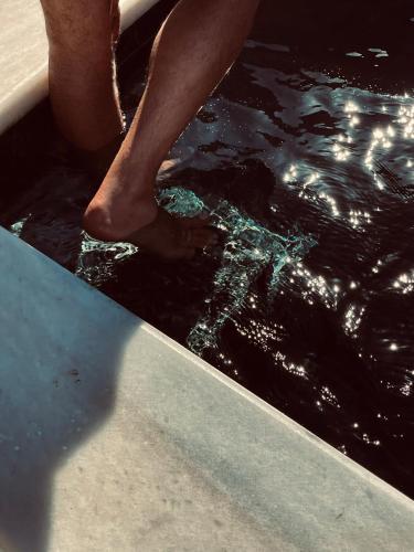 a person is standing in a pool of water at ROMEO AND JULIO SUMMER HOUSE in Mýkonos City