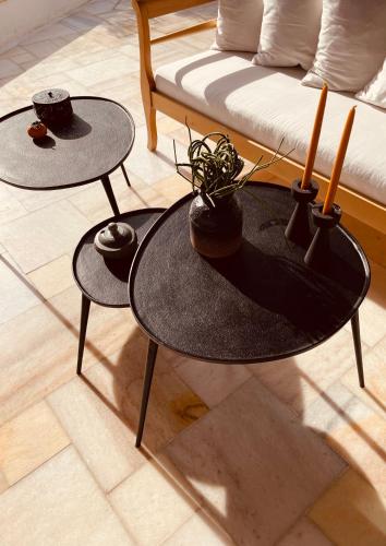 a living room with two tables and a couch at ROMEO AND JULIO SUMMER HOUSE in Mýkonos City