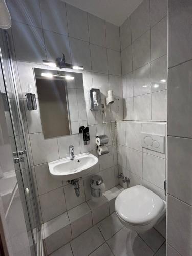 a bathroom with a toilet and a sink at WestEnd#204 in Frankfurt