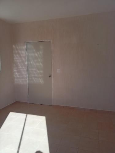 une chambre vide avec une porte et du carrelage dans l'établissement Habitación san marcos, à Mérida