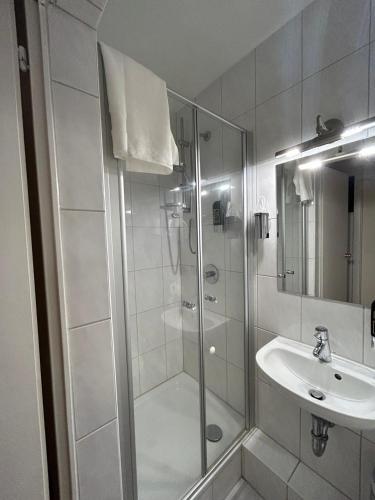 a bathroom with a shower and a sink at WestEnd#204 in Frankfurt