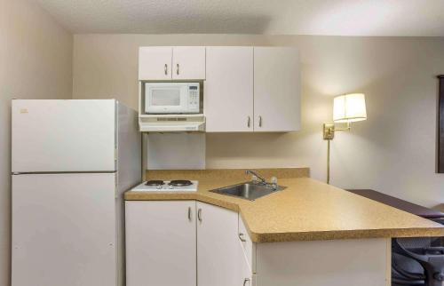 a kitchen with a white refrigerator and a sink at Extended Stay America Select Suites - Philadelphia - Malvern - Great Valley in Malvern