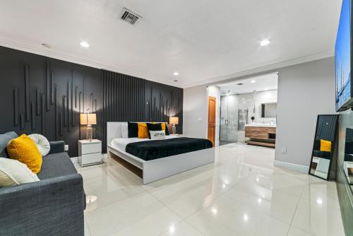 a bedroom with a bed and a couch at Oasis with Pool Spa Games 5BR L21 in Miami Gardens