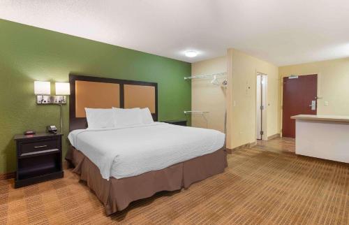 a bedroom with a large bed and a green wall at Extended Stay America Suites - Minneapolis - Airport - Eagan - South in Eagan