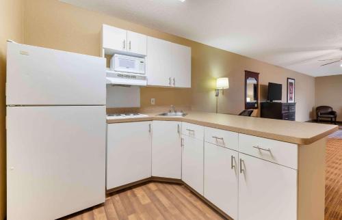 a kitchen with white cabinets and a white refrigerator at Extended Stay America Suites - Minneapolis - Airport - Eagan - South in Eagan