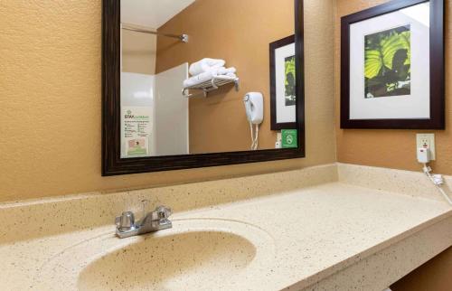 a bathroom with a sink with a mirror and a phone at Extended Stay America Suites - Minneapolis - Airport - Eagan - South in Eagan