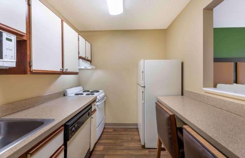 a kitchen with a white refrigerator and a sink at Extended Stay America Suites - Chicago - Lombard - Yorktown Center in Lombard