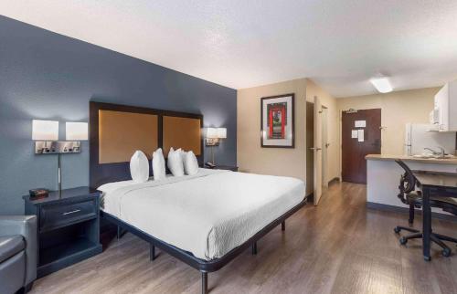 a bedroom with a large white bed and a desk at Extended Stay America Suites - Memphis - Germantown West in Memphis