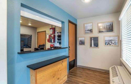 a room with a blue wall with a mirror at Extended Stay America Select Suites - Jackson - South in Byram