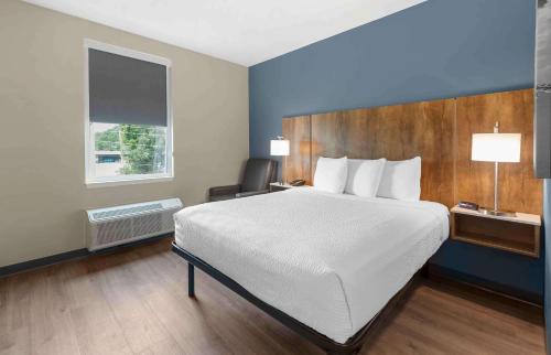 a hotel room with a large bed and a window at Extended Stay America Suites - Huntsville - Madison in Madison