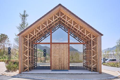 a wooden building with a large wooden door at Simose Art Garden Villa in Kuba