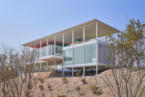 a house on top of a sand hill at Simose Art Garden Villa in Kuba