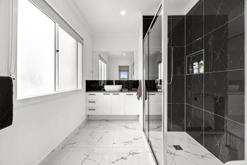 a bathroom with a walk in shower and a sink at Amazing family home opposite a park & sleeps 10 in Saint Leonards