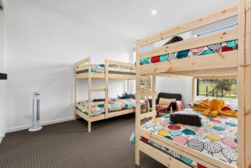 a bedroom with two bunk beds and a desk at Amazing family home opposite a park & sleeps 10 in Saint Leonards
