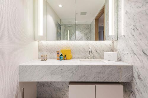 a bathroom with a sink and a mirror at ARCORE Premium Apartments London Bridge in London