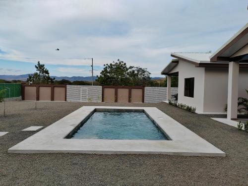 una piscina en un patio junto a una casa en Villas Brisas de Soley, en La Cruz