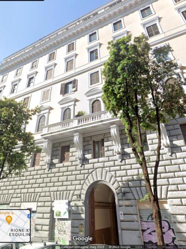 a large white building with an arch in front of it at Bretone XI b&b in Rome