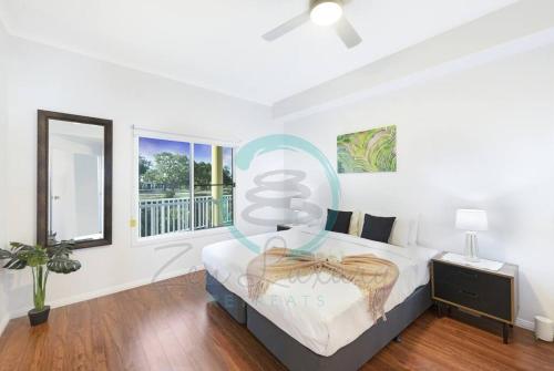 a bedroom with a large bed and a window at Zen Marina: 1-BR Executive Apartment By The Bay in Larrakeyah