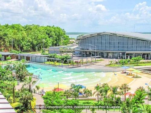 an artist rendering of the expansion of the convention centre water park resort at Zen Marina: 1-BR Executive Apartment By The Bay in Larrakeyah