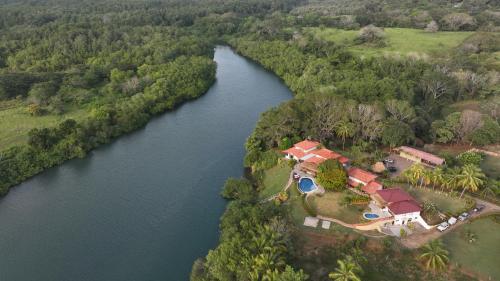 an aerial view of a house next to a river at Casa Caletas Boutique Hotel in Puerto Coyote