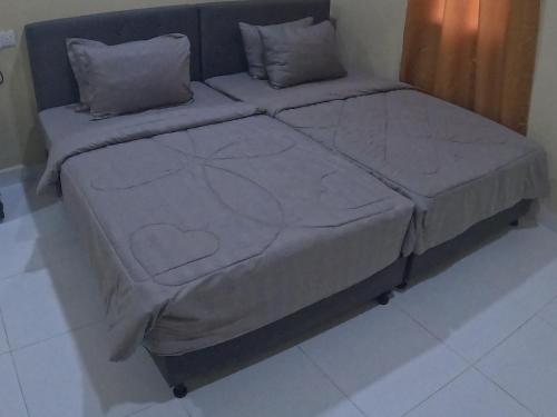 a large bed sitting in a room with at NURUL ROOMSTAY LANGKAWI in Pantai Cenang