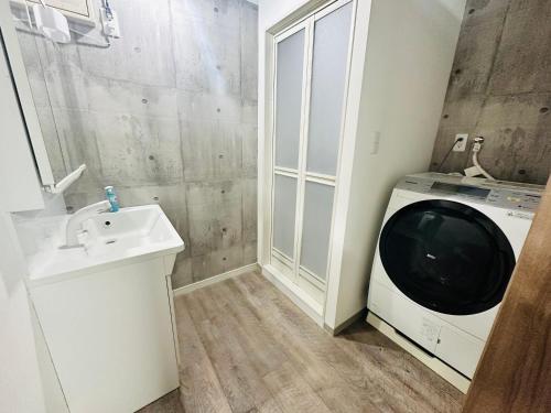 a bathroom with a sink and a washing machine at yokohama paradise101 in Yokohama