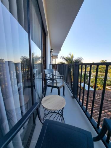a balcony with two chairs and a table at Guatapé Country House Hotel in Guatapé