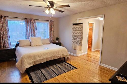 1 dormitorio con 1 cama y ventilador de techo en Entire Home w/ Free Wi-Fi, Garage, Deck, Yard, en Nixa