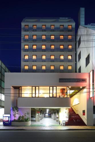 a large building with a staircase in front of it at Okayama View Hotel in Okayama
