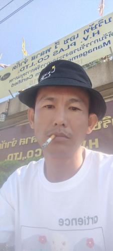 a young man wearing a hat with a cigarette in his mouth at Kyaw Swar Hein 