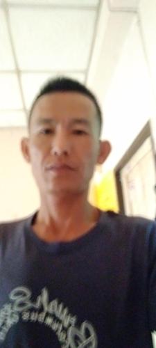 a man standing in a room wearing a blue shirt at Kyaw Swar Hein 