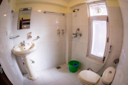 a bathroom with a sink and a shower and a toilet at Hotel Yambu kathmandu in Kathmandu