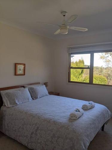 a bedroom with a bed with two towels on it at Bonnie Belle Escape in Little Hartley