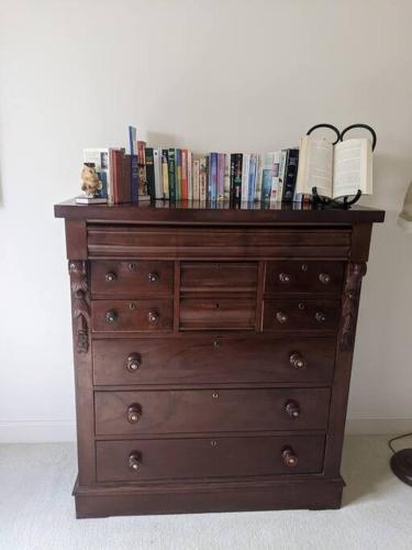 a wooden dresser with books on top of it at Bonnie Belle Escape in Little Hartley