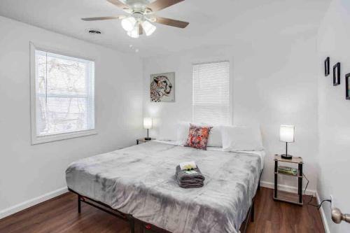 a bedroom with a large bed with a ceiling fan at Tiny Home w/ King Bed mins DTWN in Rochester