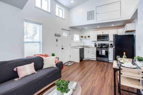 a living room with a couch and a kitchen at Tiny Home w/ King Bed mins DTWN in Rochester